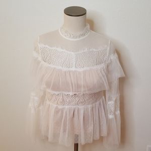 White long sleeve blouse with a chic sheer design